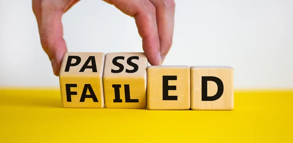 Wooden blocks being changed from “failed” to “passed,” representing the results of a dyno test.